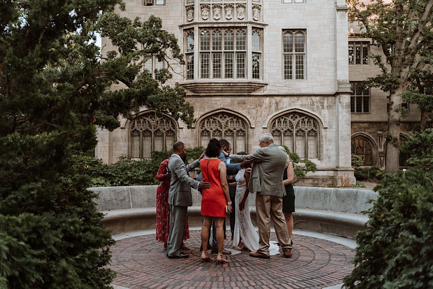 Bride, groom and family share prayer after University of Chicago elopement ceremony