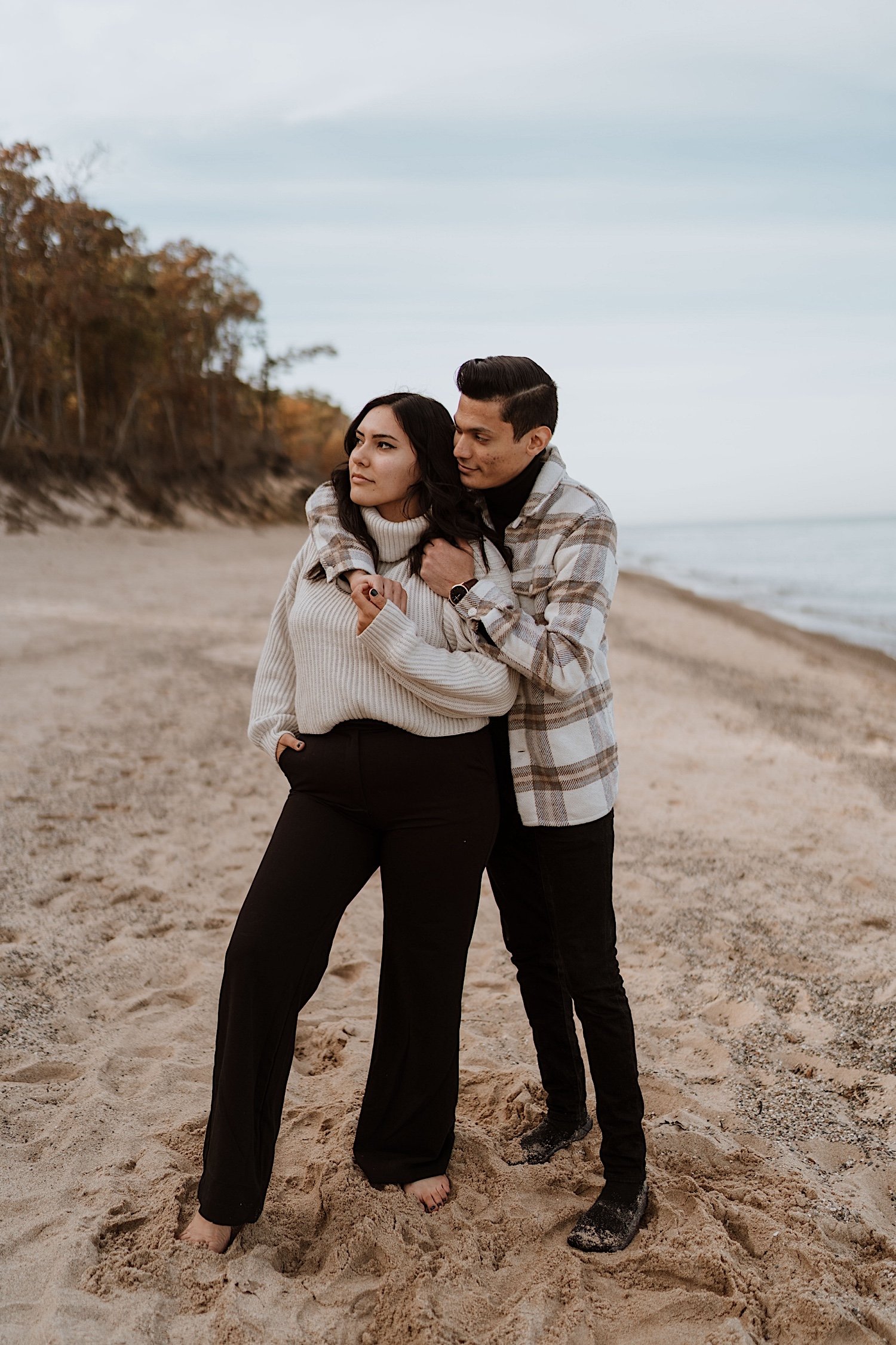 Couple pose on beach of Indiana Dunes for anniversary session