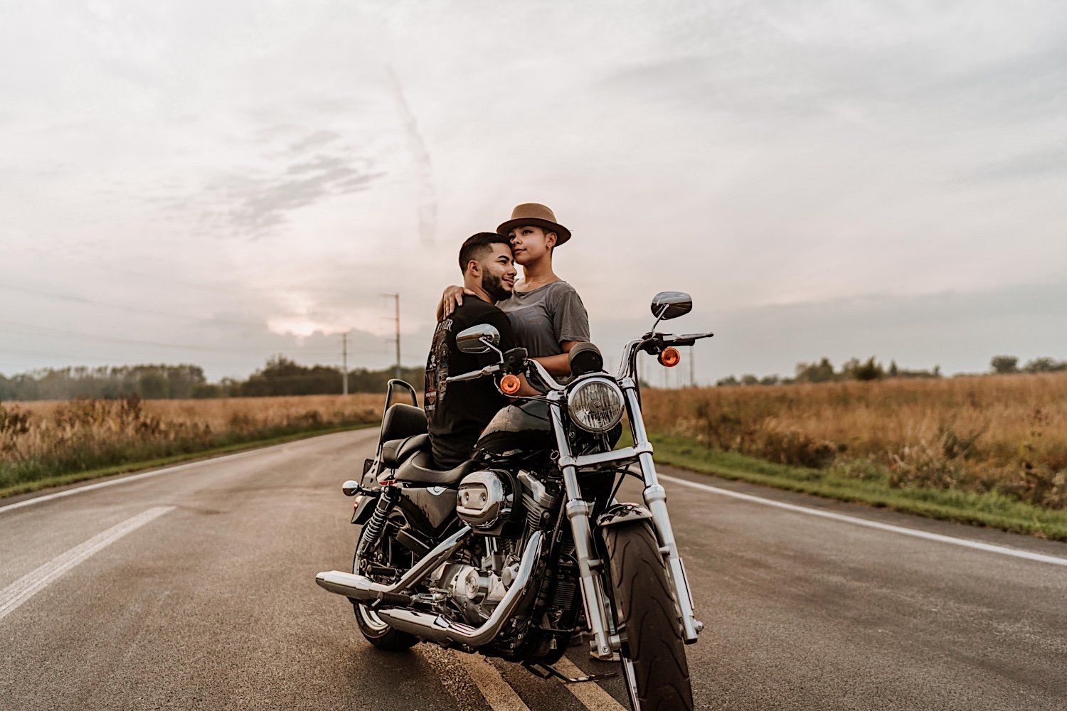 Couple sits on motorcycle in middle of the road before surprise proposal