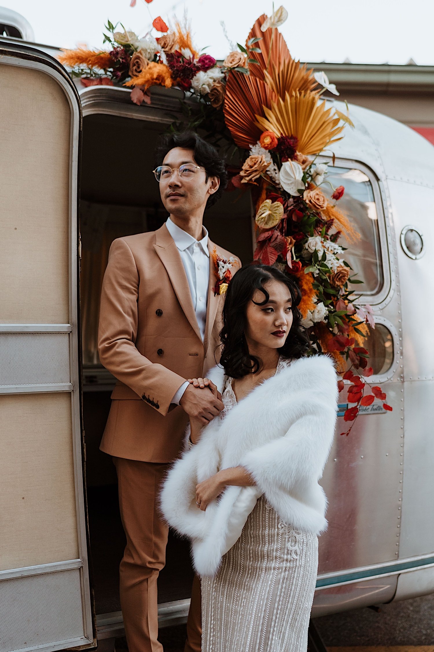 Couple pose in front of RV on Cincinnati street during elopement