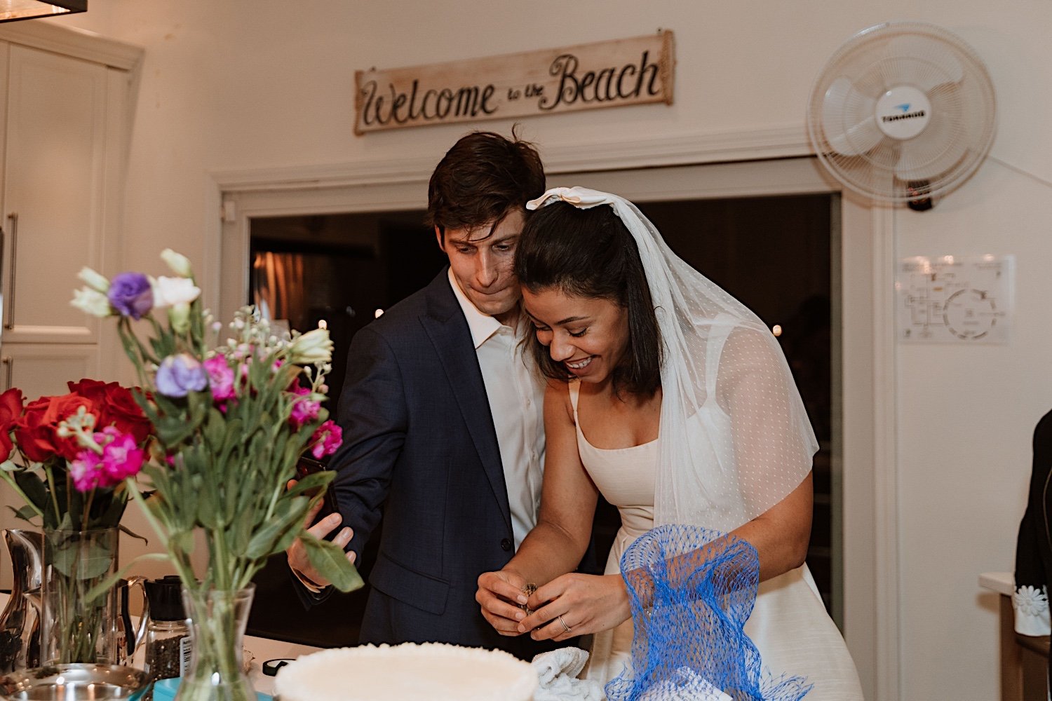 Bride and groom cut cake at intimate Indiana wedding reception