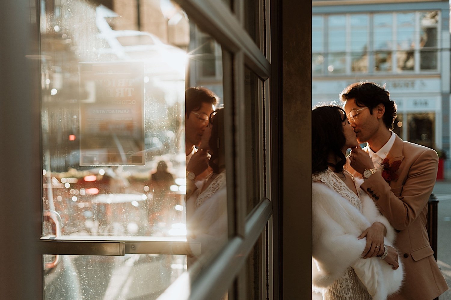 Couple kiss next to store in Findlay Market for Cincinnati elopement