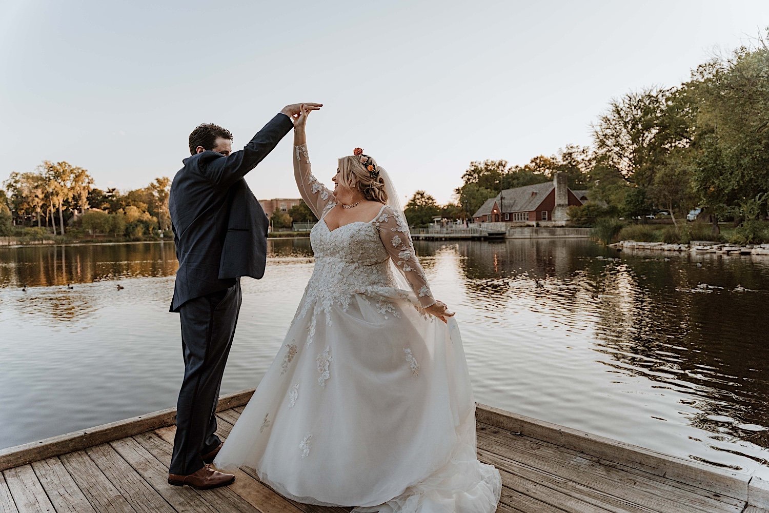 Bride and groom dance on pier at Lake Ellyn Boathouse wedding