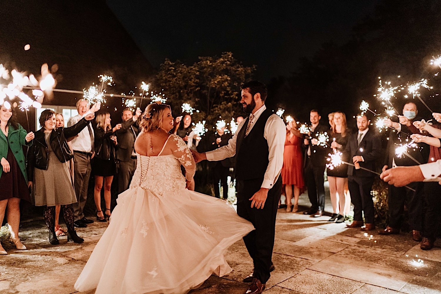 Bride and groom share first dance surrounded by sparklers at Lake Ellyn Boathouse wedding