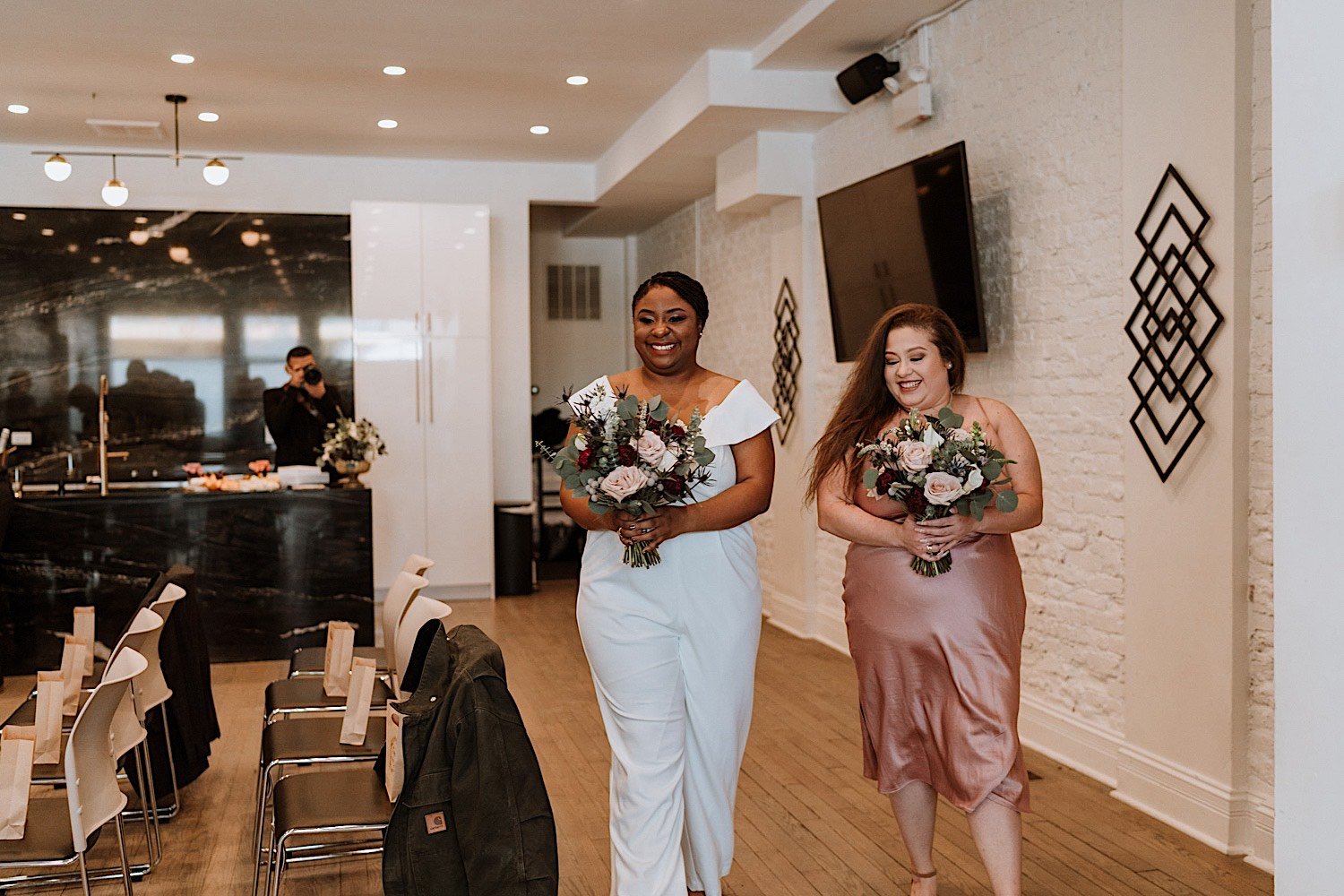 Brides walking down the aisle together of their Humboldt Park wedding holding flowers
