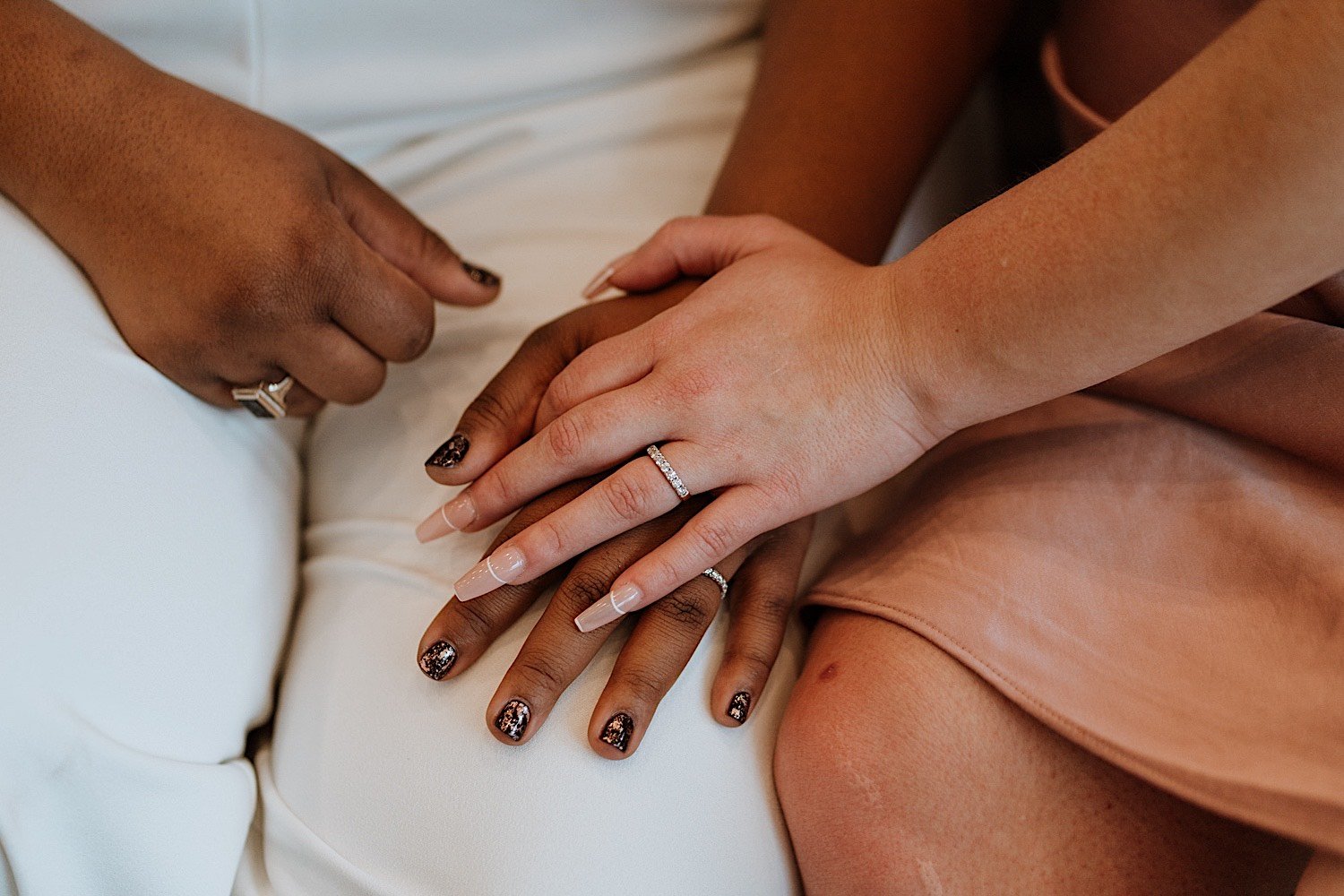 Brides hands with wedding rings holding one another
