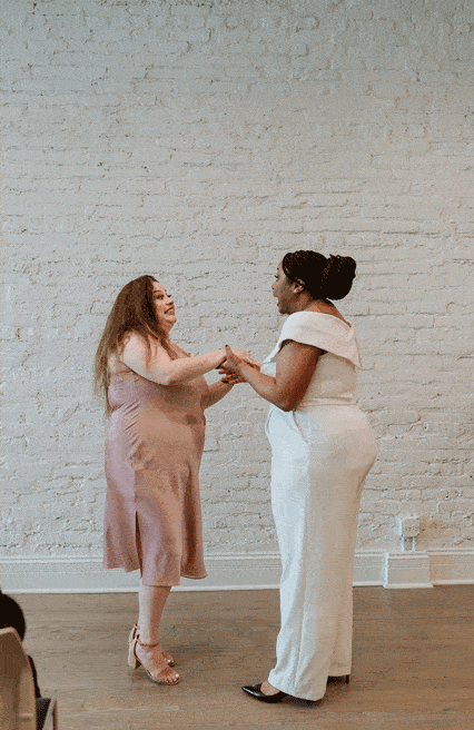 Gif of brides laughing together during their wedding Ceremony