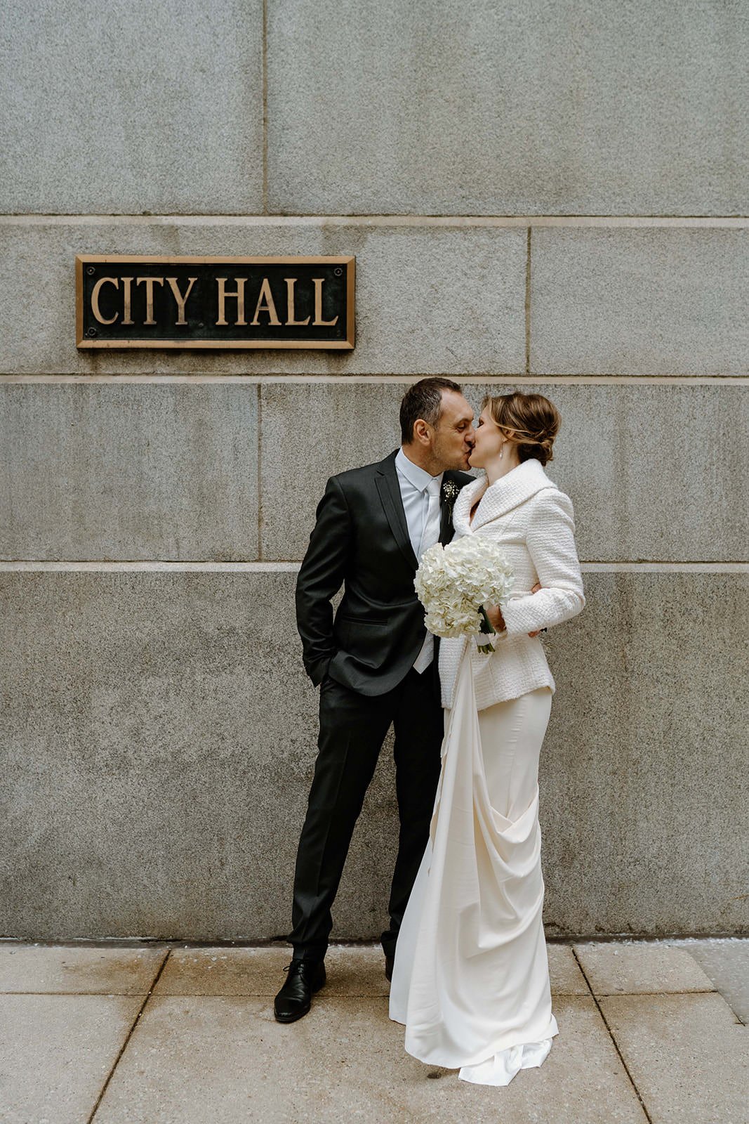 newly-weds takes a photo outside of City Hall