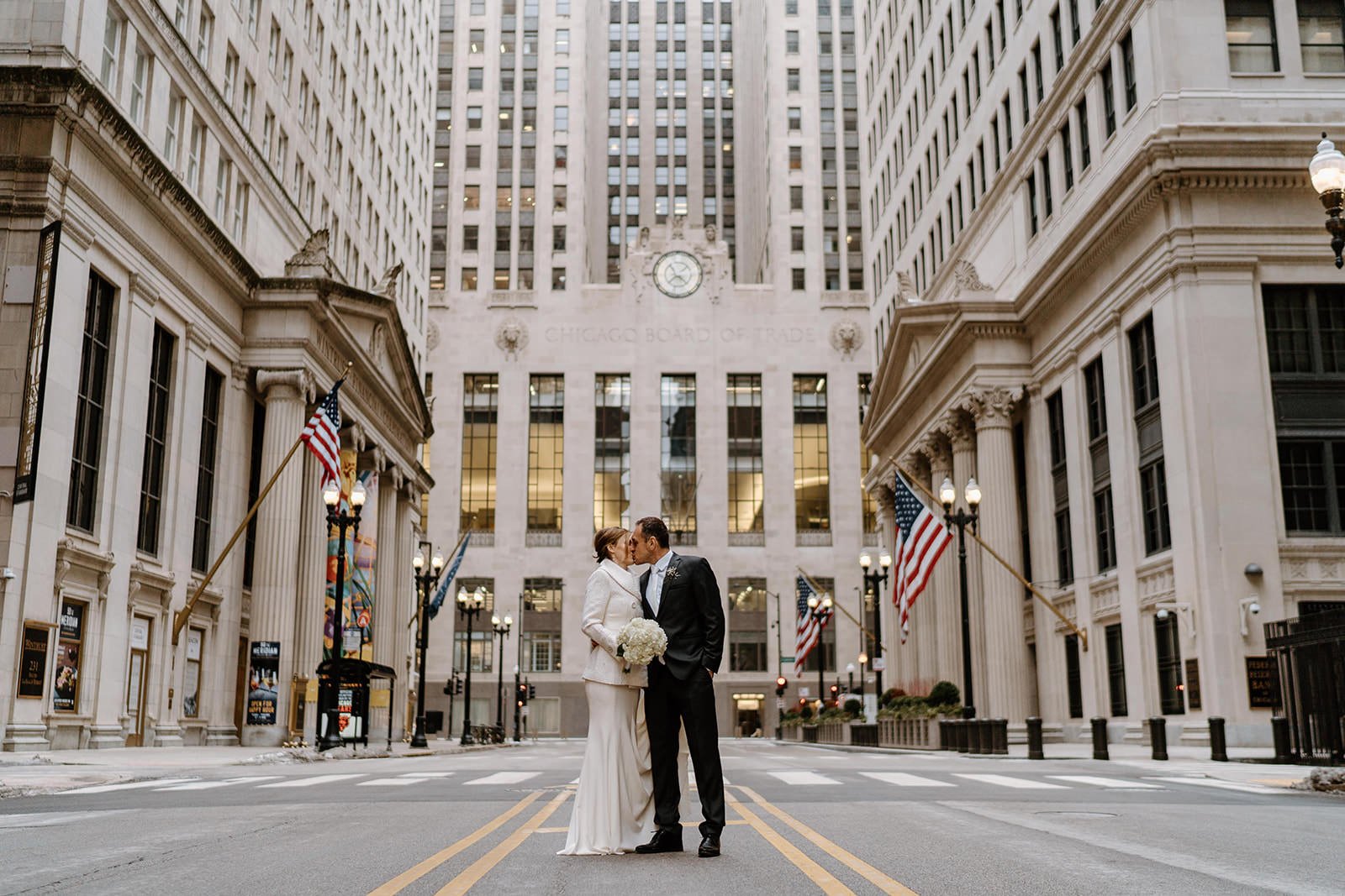 Couple poses in front of the Chicago Board of Trade building