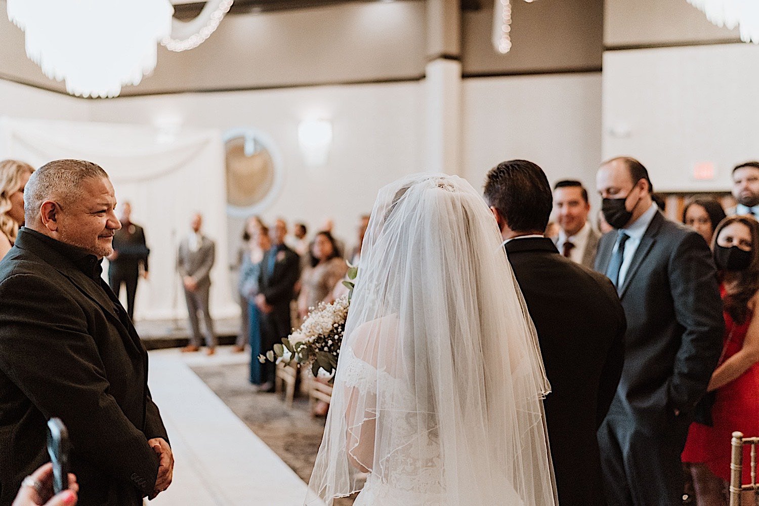 Bride and father walking down the aisle together at her Chicagoland ballroom wedding
