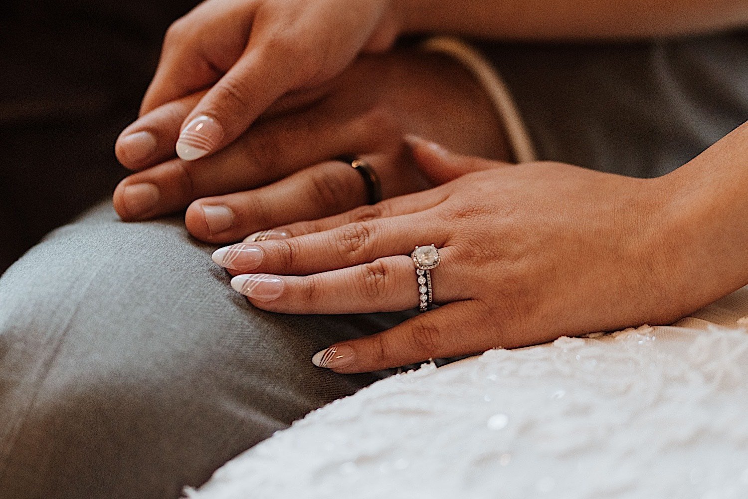 Closeup of bride and grooms hands with their wedding rings on
