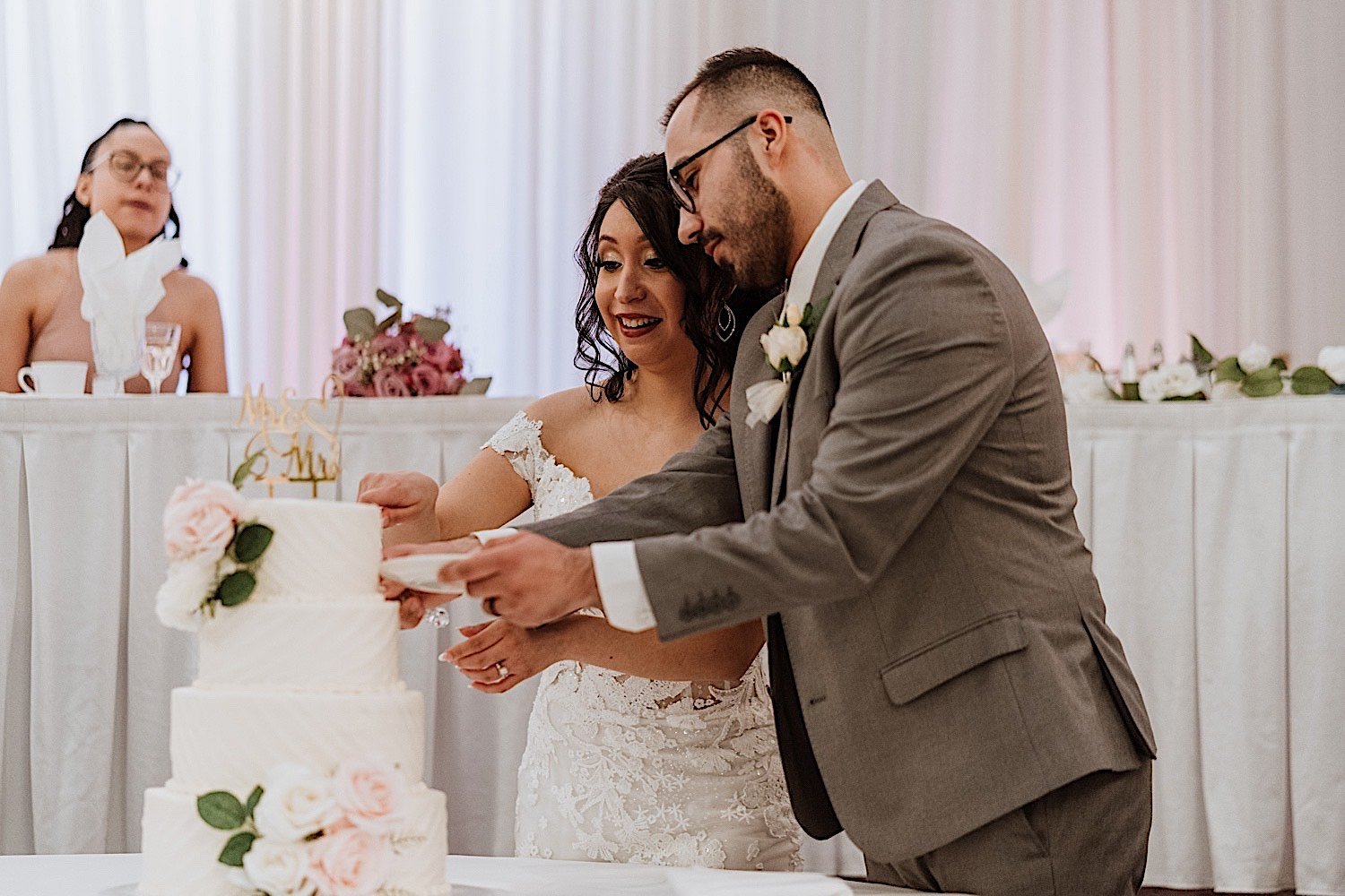 Bride and groom cut the cake during their Chicagoland ballroom wedding reception