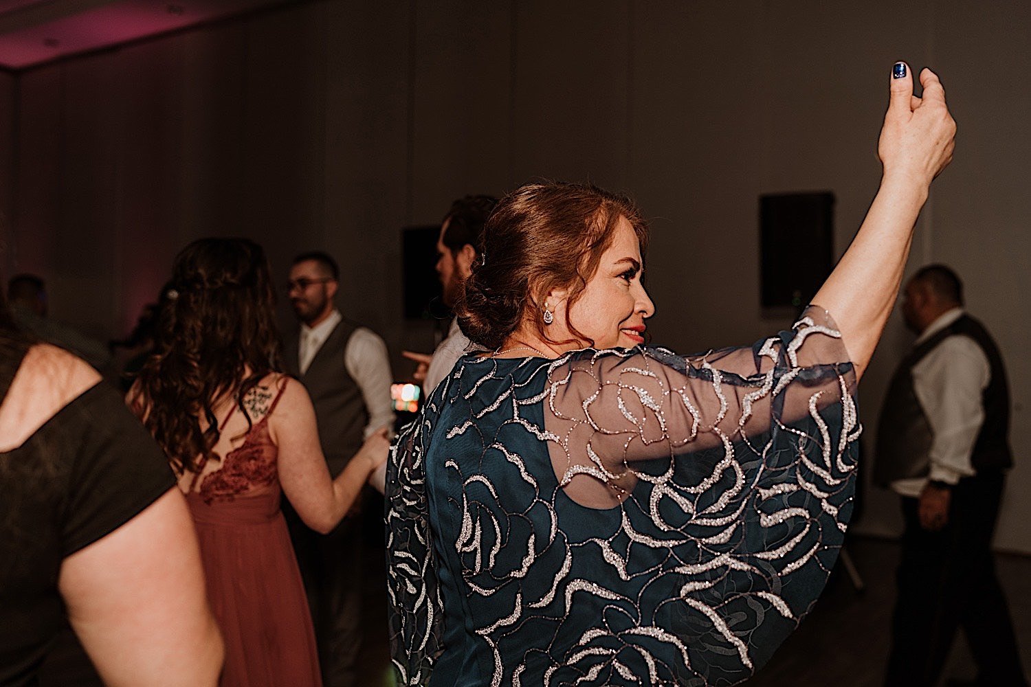 Mother to the groom dances surrounded by guests during Chicagoland ballroom wedding reception
