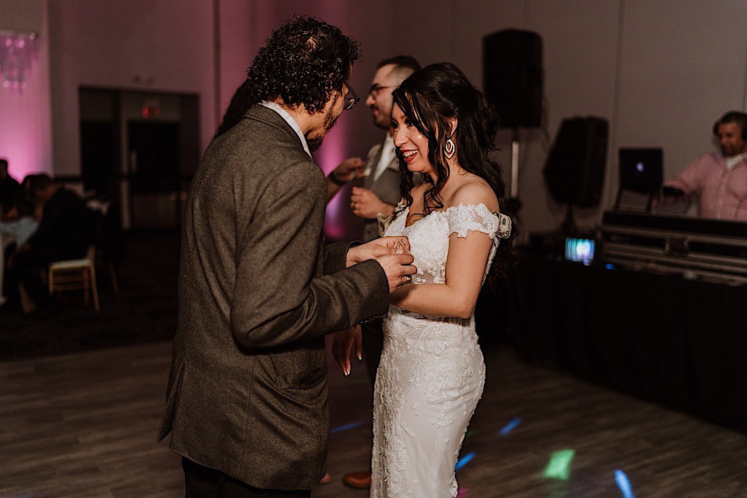 Bride talks with a guest on the dance floor during wedding reception