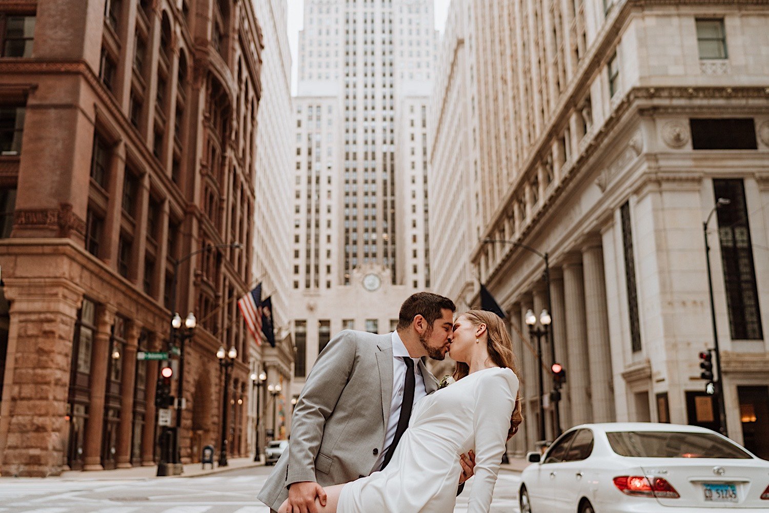 chicago elopement - groom leans in to bride as he dips her and gives her a kiss