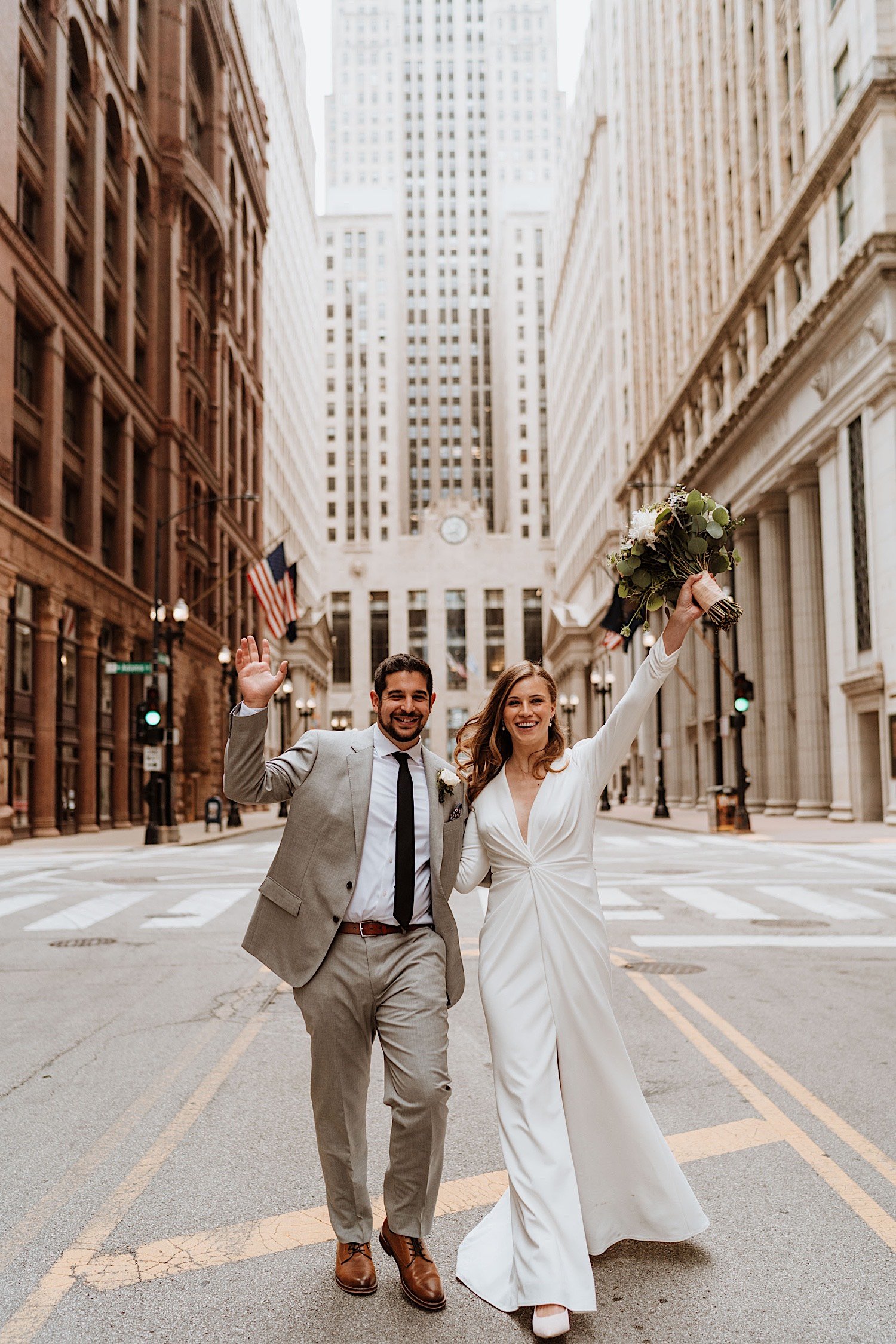 chicago elopement - bride and groom raises their hand to show celebration to the camera