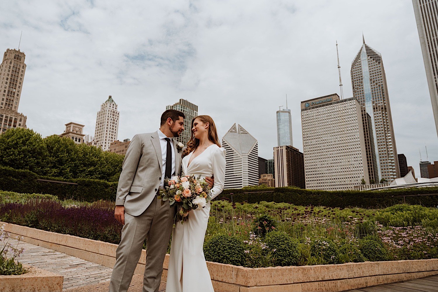 chicago elopement - newlyweds at the Lurie Gardens with the Chicago skyline behind them