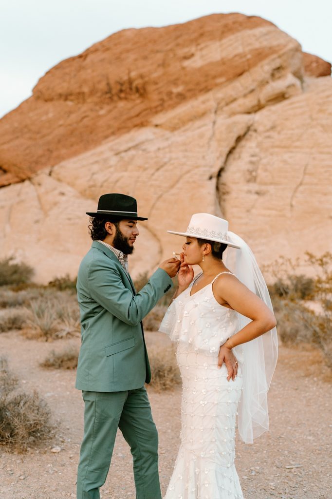 The bride and groom lighting a joint during their Las Vegas Elopement