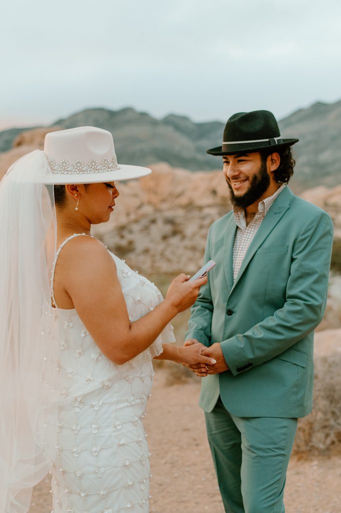 The bride and groom exchange their vows privately surrounded by the red rocks in Las Vegas.