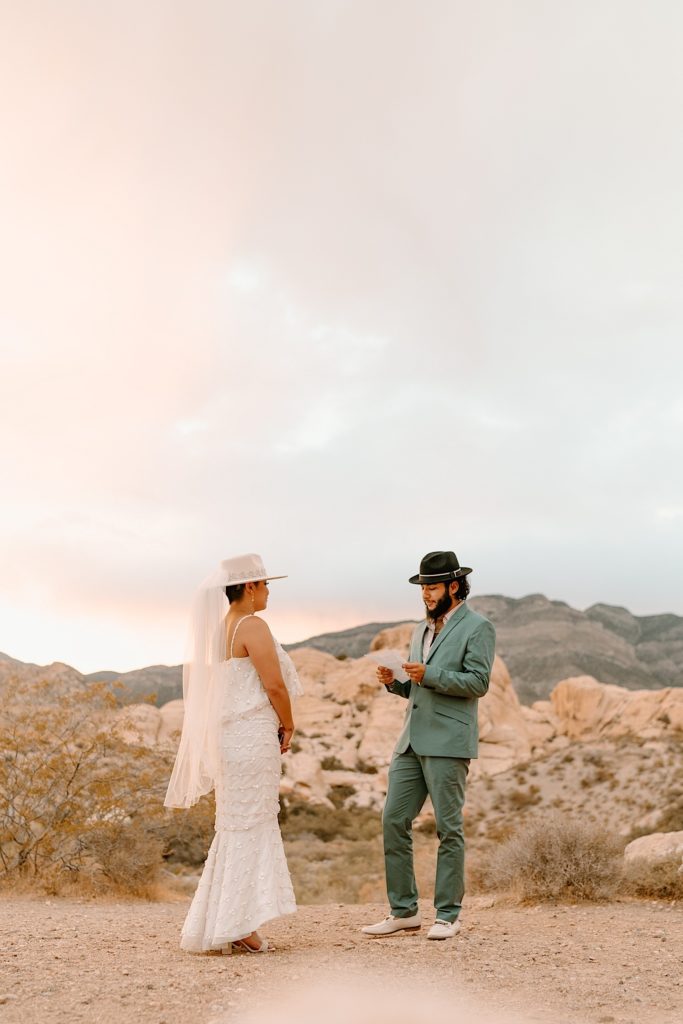 The bride and groom exchanged their vows privately surrounded by the red rocks in Las Vegas while the sun sets