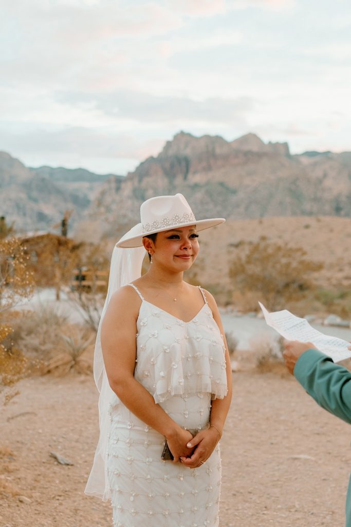 The bride and groom exchanged their vows privately surrounded by the red rocks in Las Vegas while the sun sets