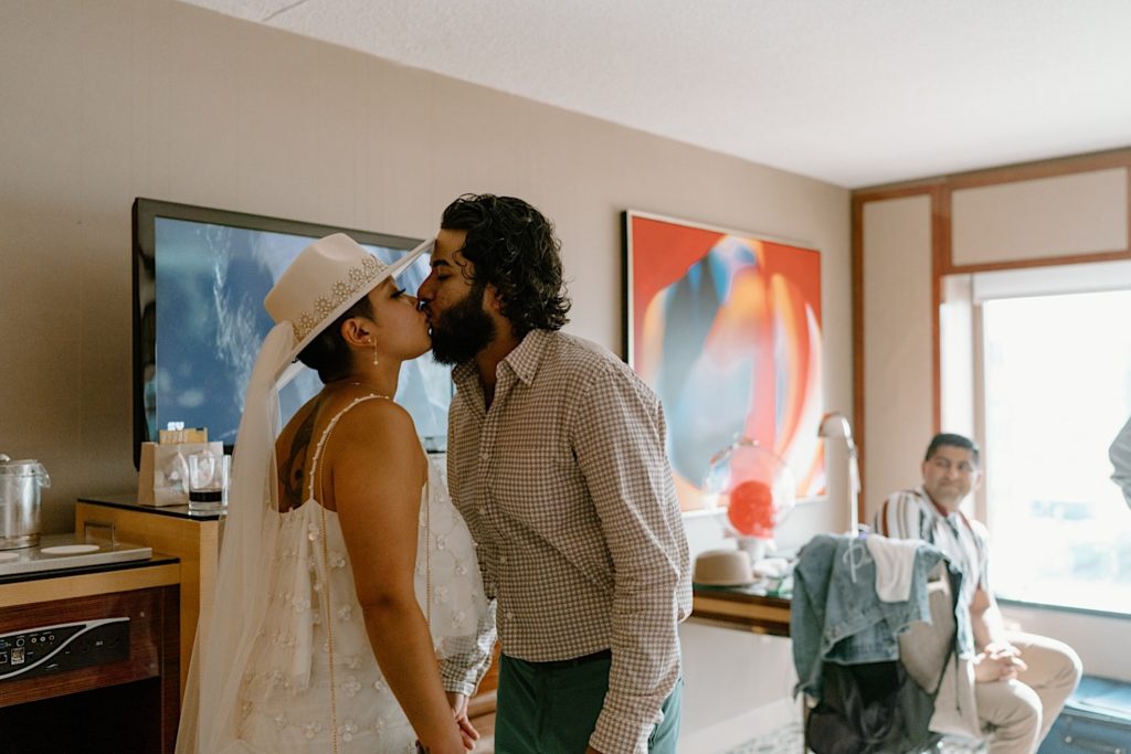 The bride and groom kiss after getting ready for their elopement in Las Vegas.