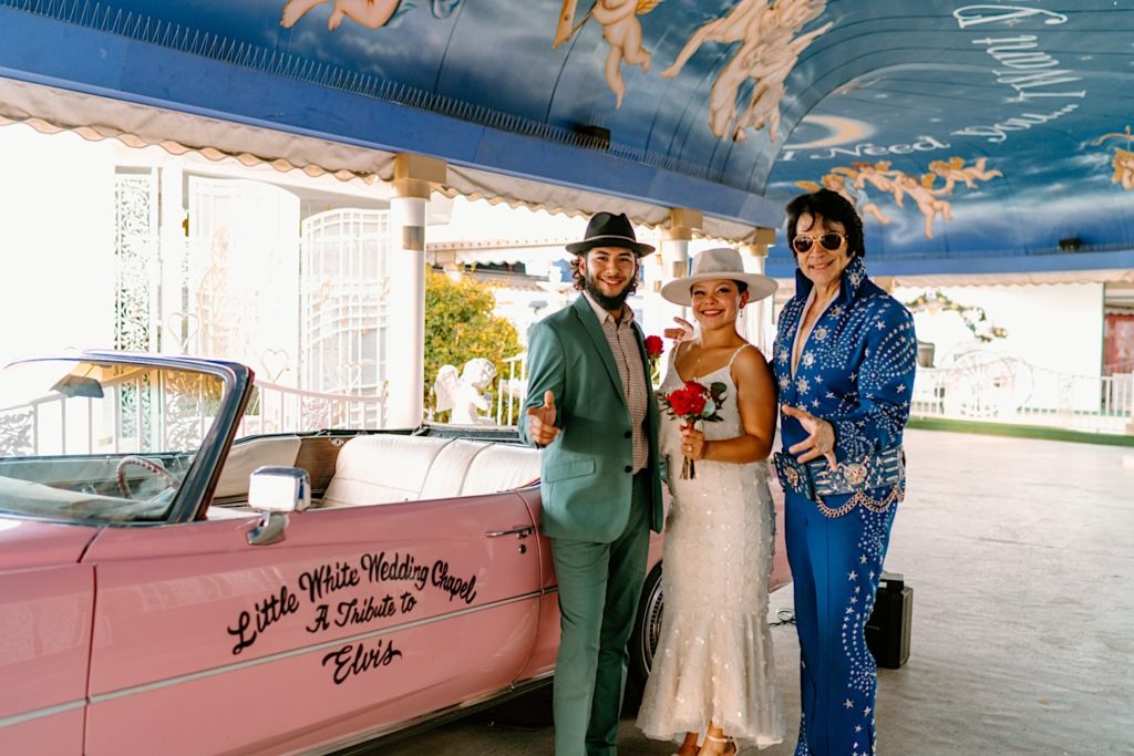 The bride and groom dance and celebrate next to Elvis after getting married in Las Vegas