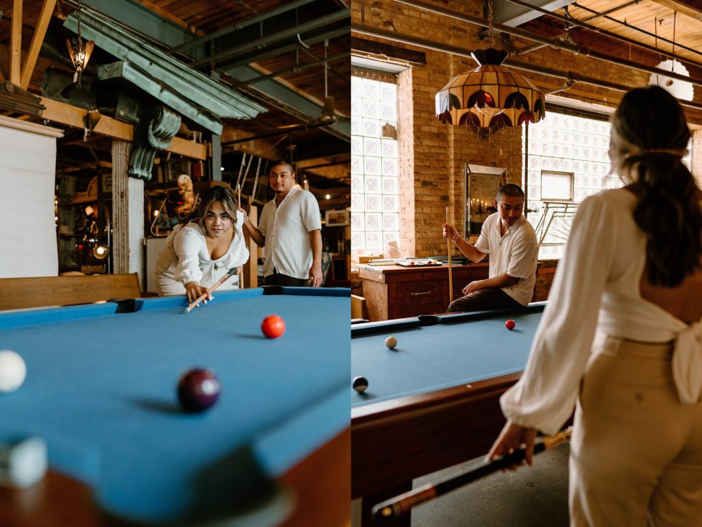 A couple plays pool during their Chicago engagement session at Salvage one, they are leaning over the pool table deciding their next moves.