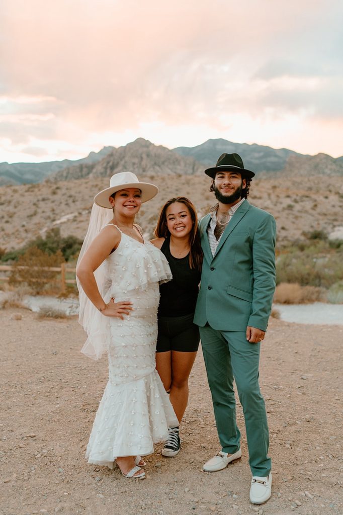 Kriztelle Halili, elopement photographer stands with her elopement clients in Las Vegas Nevada.