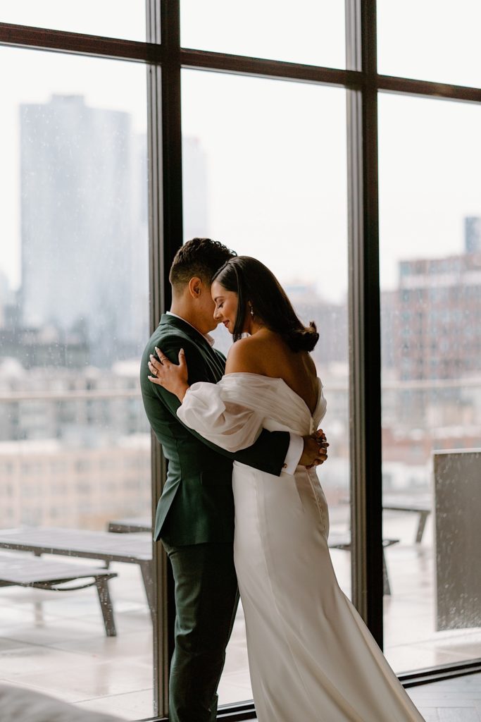 A bride and groom see one another for the first time the morning of their wedding during their first look at a Chicago Airbnb.