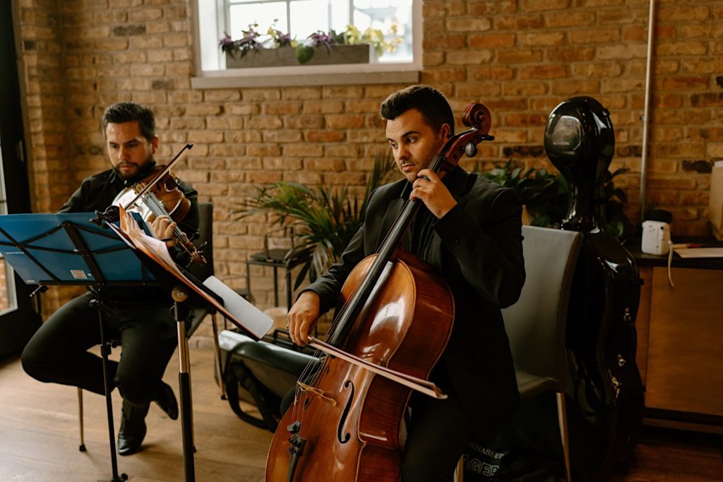 A small orchestra plays their instruments prior to the wedding ceremony at Loft Lucia.