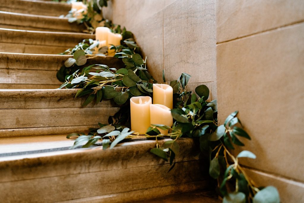 Candles and greens lining the stairway for a wedding at Joliet's Union Station.