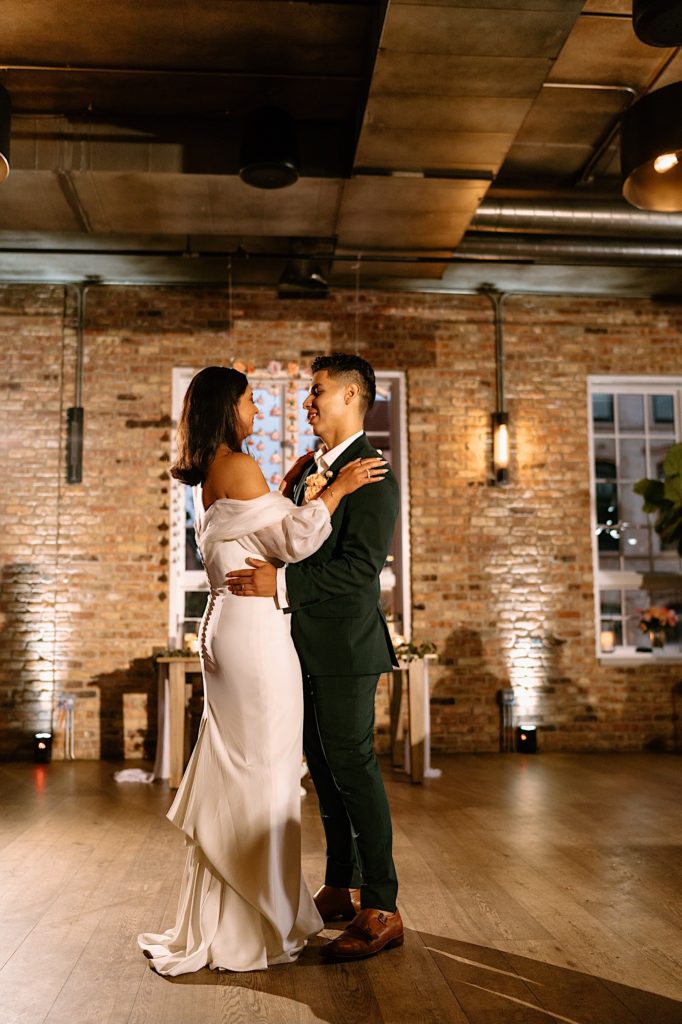 The bride and groom share their first dance on their wedding day at Loft Lucia.