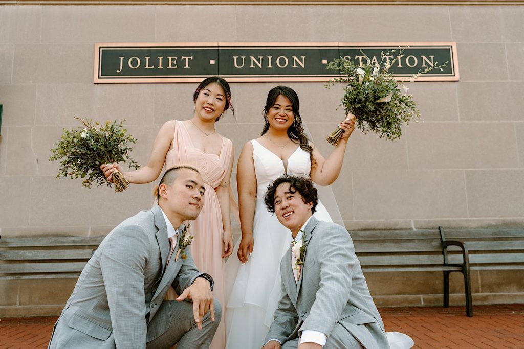 A bride poses with her bridal party prior to her wedding ceremony at Joliet Union Station.