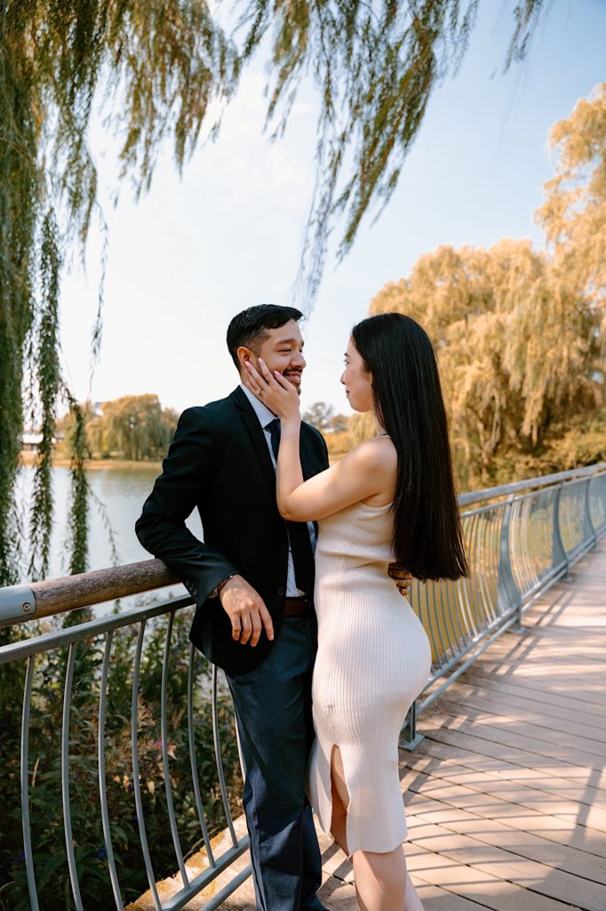A couple holds one another after their proposal at the Chicago Botanic Gardens.