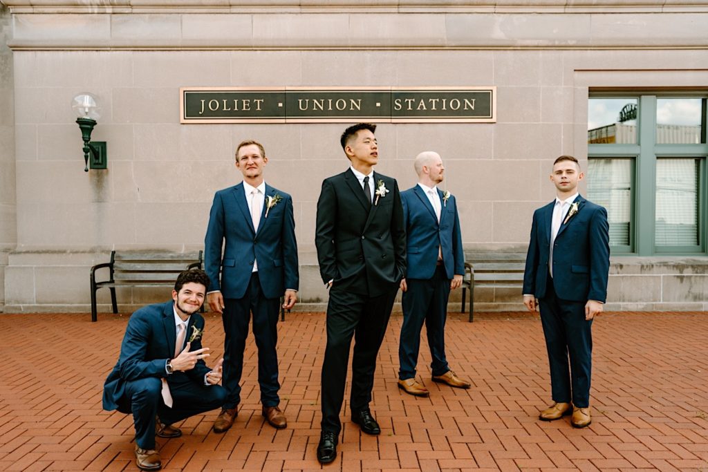 A groom stands with his bridal party prior to his wedding ceremony at Joliet Union Station.