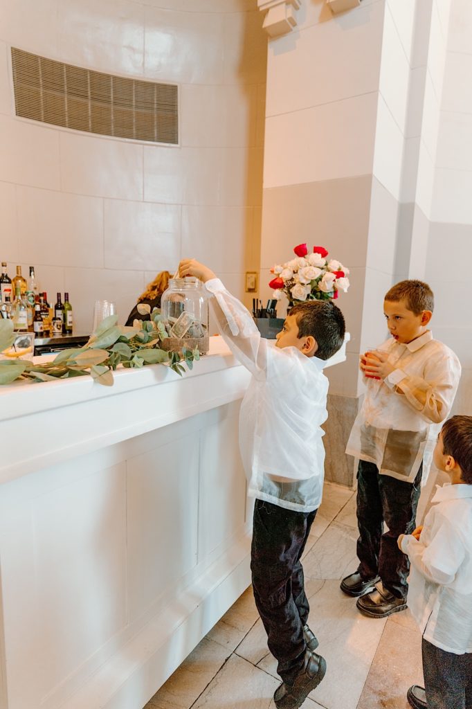 A young guest tips the bar at a wedding reception at Joliet Union Station.