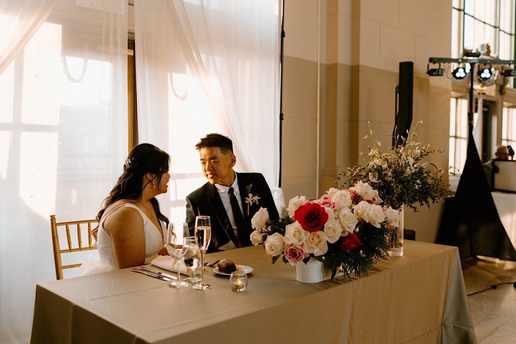A bride and groom talk amongst one another during their reception at Joliet Union Station.