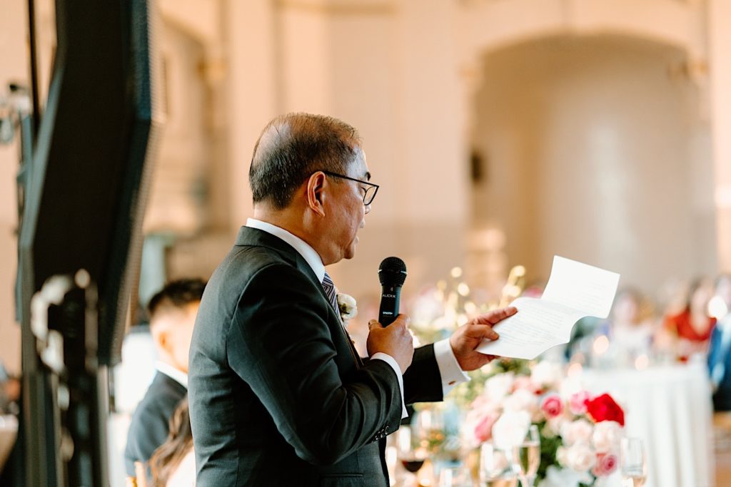 The father of the bride shares a toast with the guests of his daughters wedding.