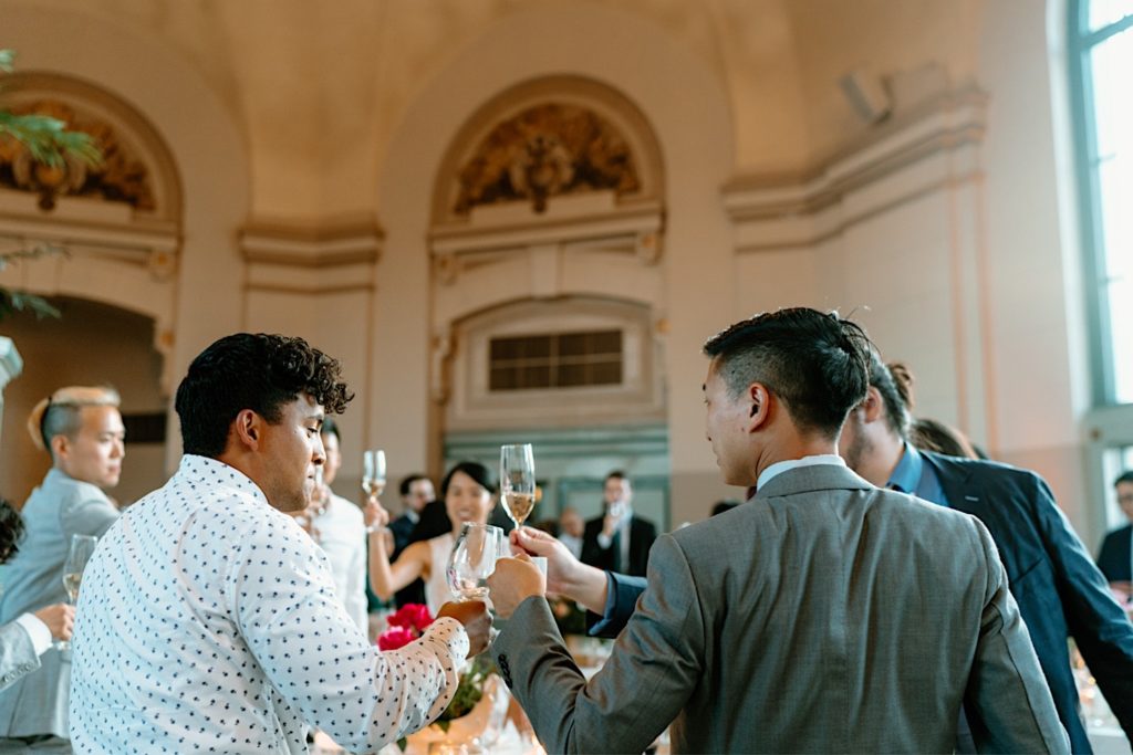 Guests share a toast for the bride and groom at their Joliet Union Station Wedding.
