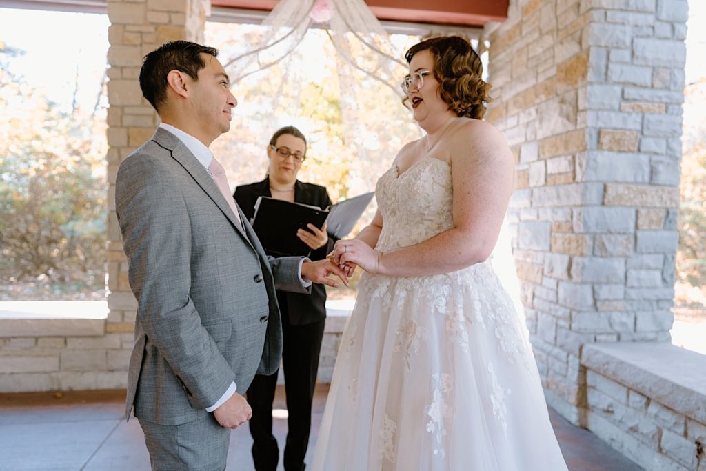 A bride and groom exchange vows at their elopement ceremony at the Grove Redfield Estate.