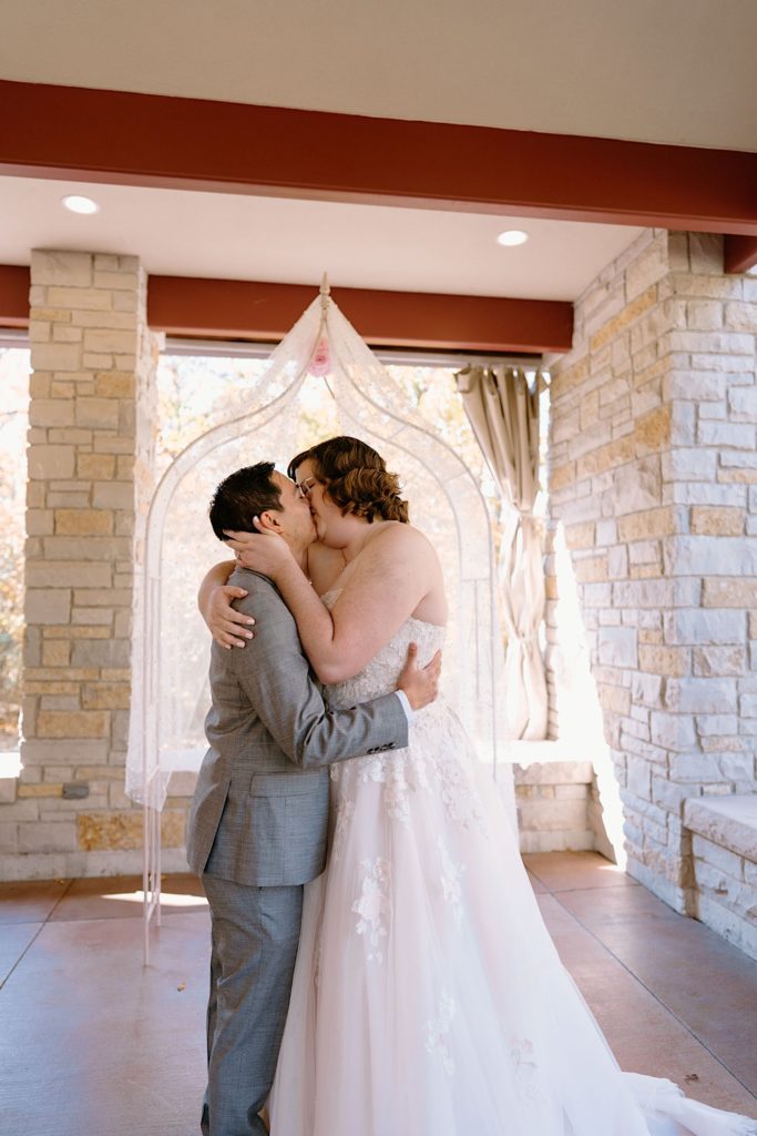 A bride and groom kiss at their elopement ceremony at the Grove Redfield Estate.