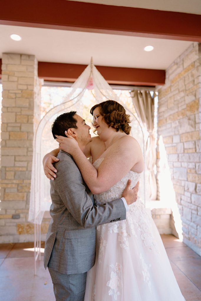 A bride and groom kiss at their elopement ceremony at the Grove Redfield Estate.