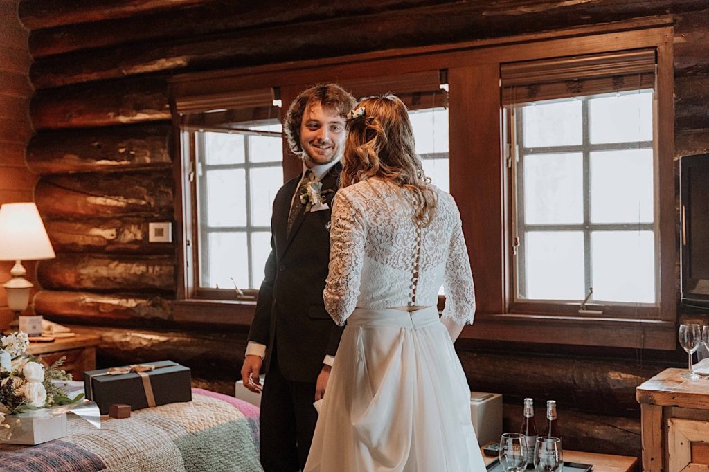 A groom sees his bride for the first time during their first look on their wedding day at Starved Rock State Park.