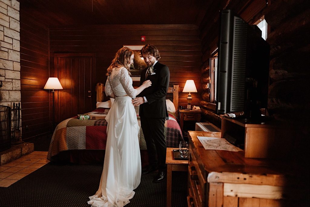 A bride and groom check out each others wedding attire in their cabin before their elopement at Starved Rock State Park.