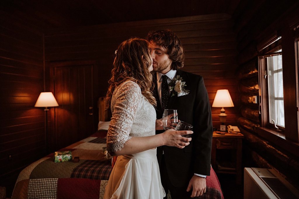 A bride and groom kiss one another in their cabin at Starved Rock.