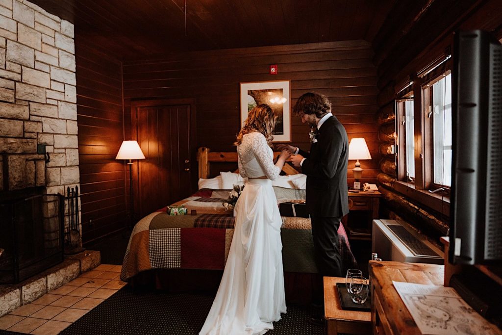 A bride and groom look at gifts they gave one another in their cabin at Starved Rock.