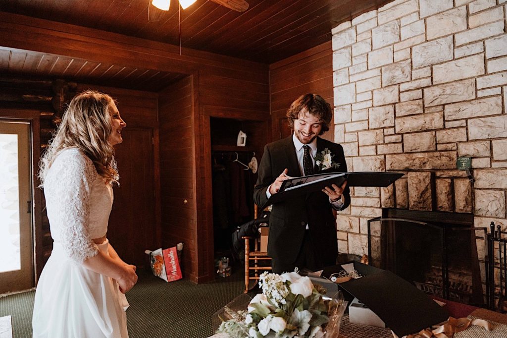 A groom opens a gift from his bride the morning of their elopement at Starved Rock National Park