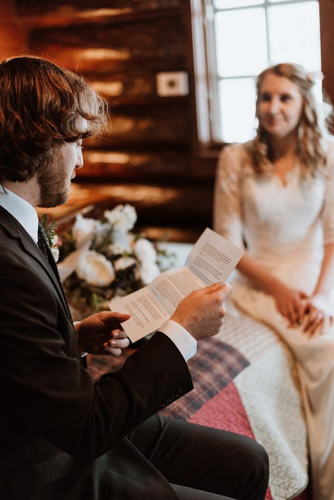 A groom sit reading letters to one another while reading letters from family and friends before they elope at Starved Rock National Park