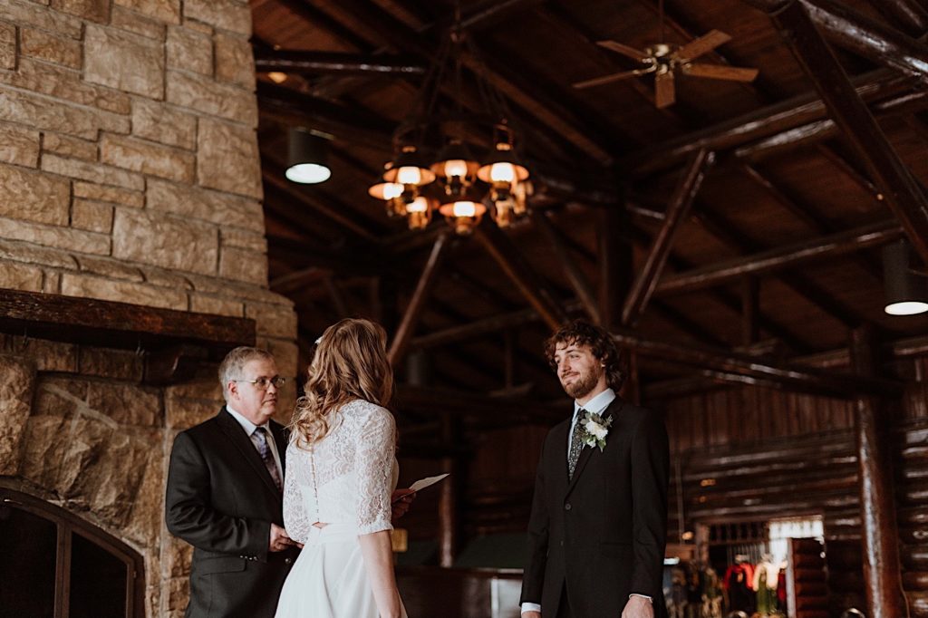A bride and groom stand during their wedding ceremony at a cabin in Starved Rock National Park.